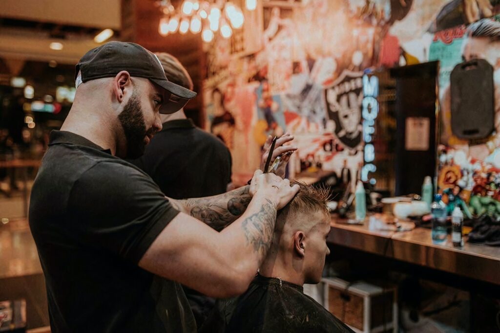Antony Locke cutting hair on a customer