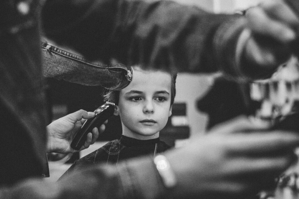 Antony Locke performs a hair cut on a child